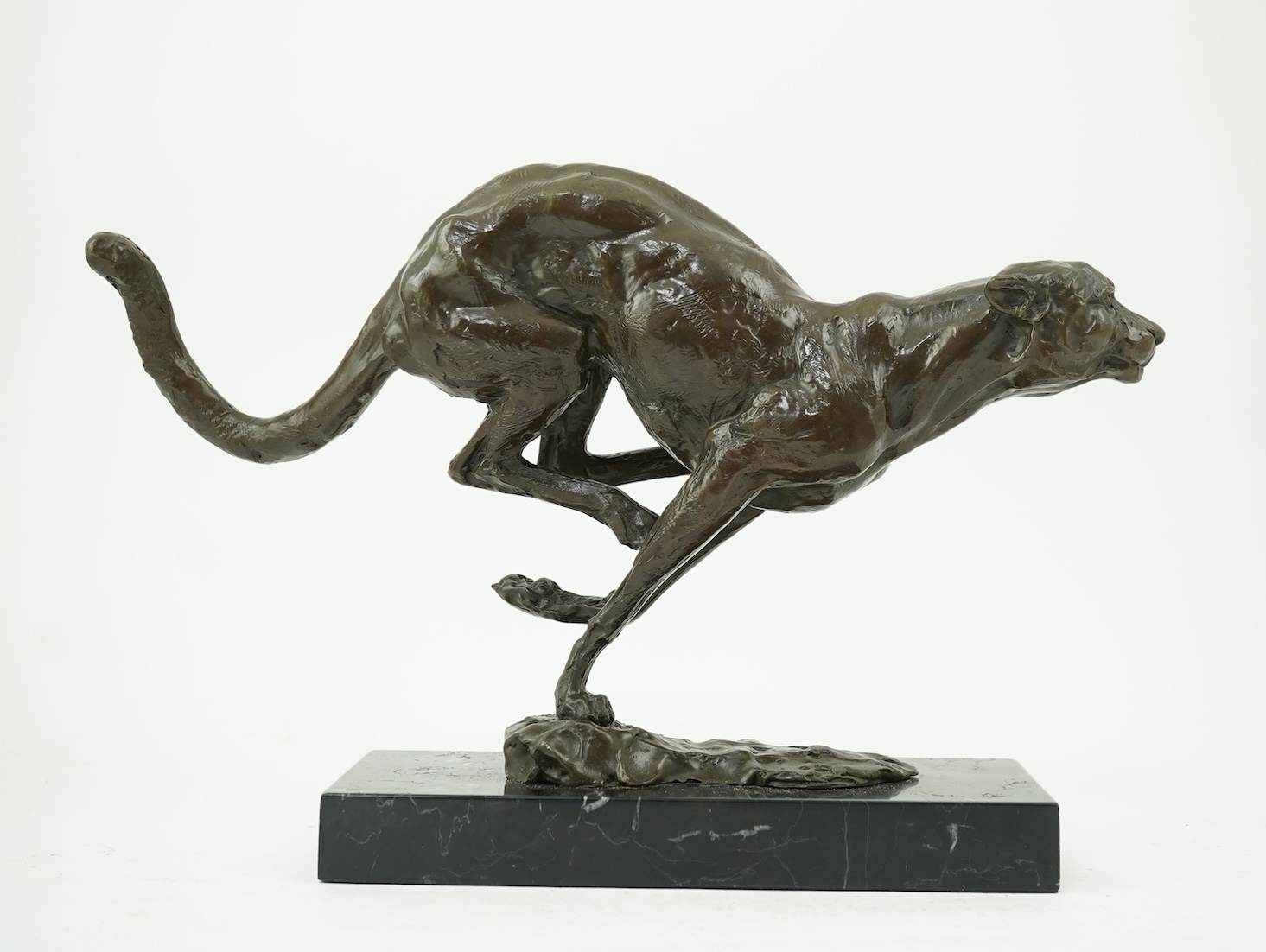 Manner of Mark Coreth (b. 1958): A patinated bronze model of a cheetah in full flight